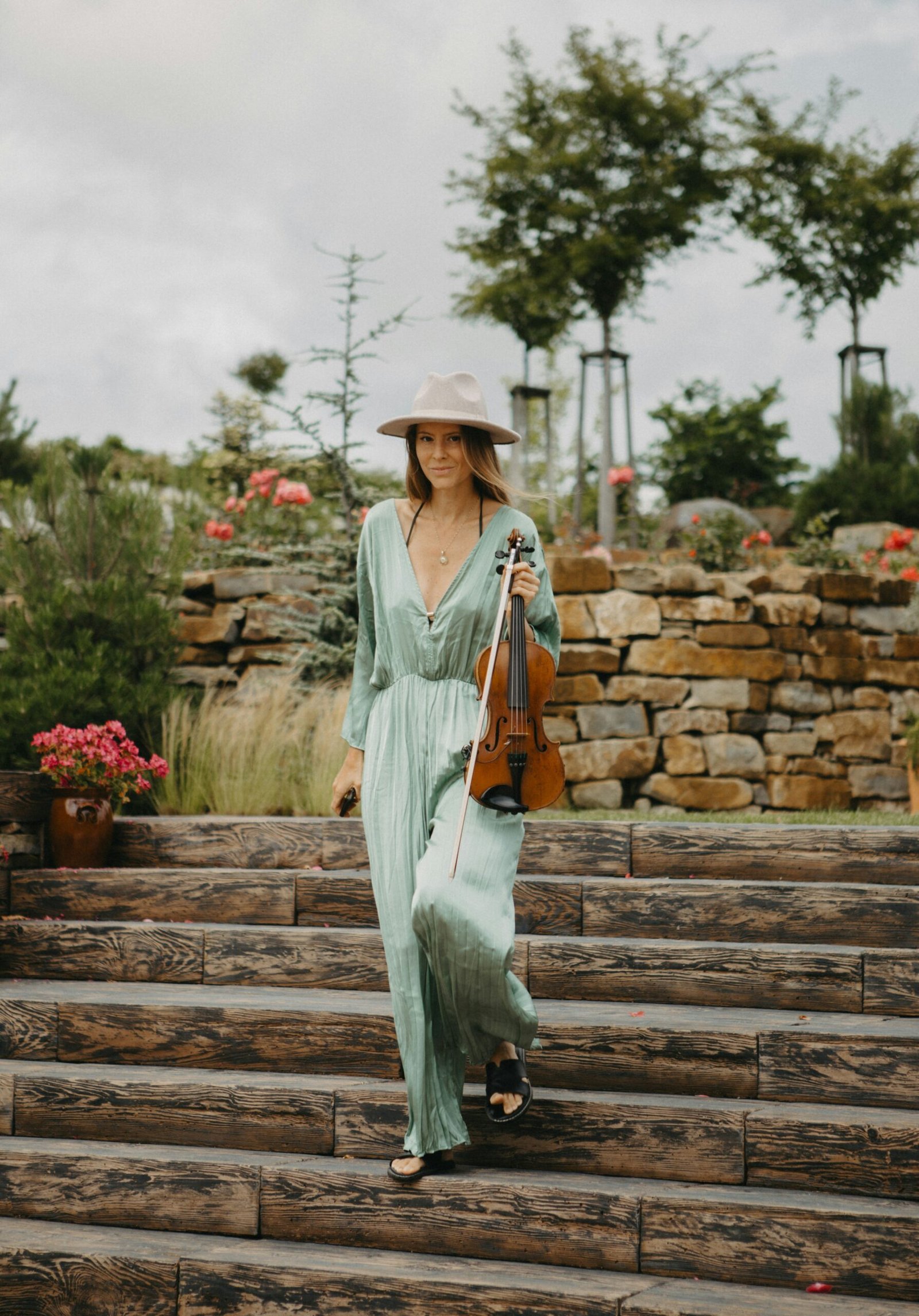 A woman in a hat walking up some steps