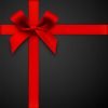 Vector illustration. Red gift bow with ribbons on a black background.